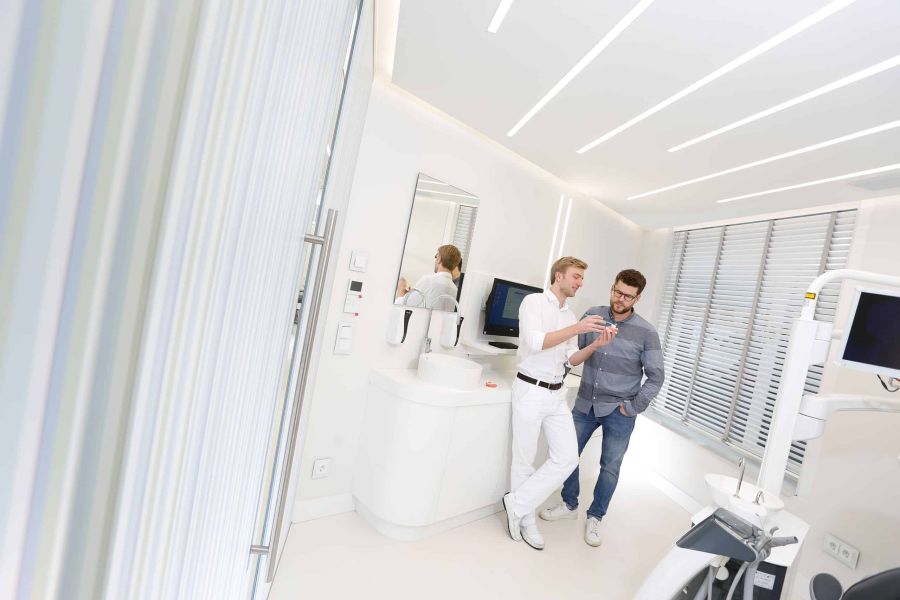 Dr. Thomsen berät einen Patienten zur richtigen Verwendung einer Zahnbürste in der Praxis von Dental Protection in Hamburg-Eimsbüttel.